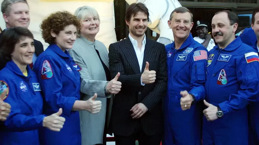 Cruise posed with astronauts after narrating a documentary about the ISS in 2002