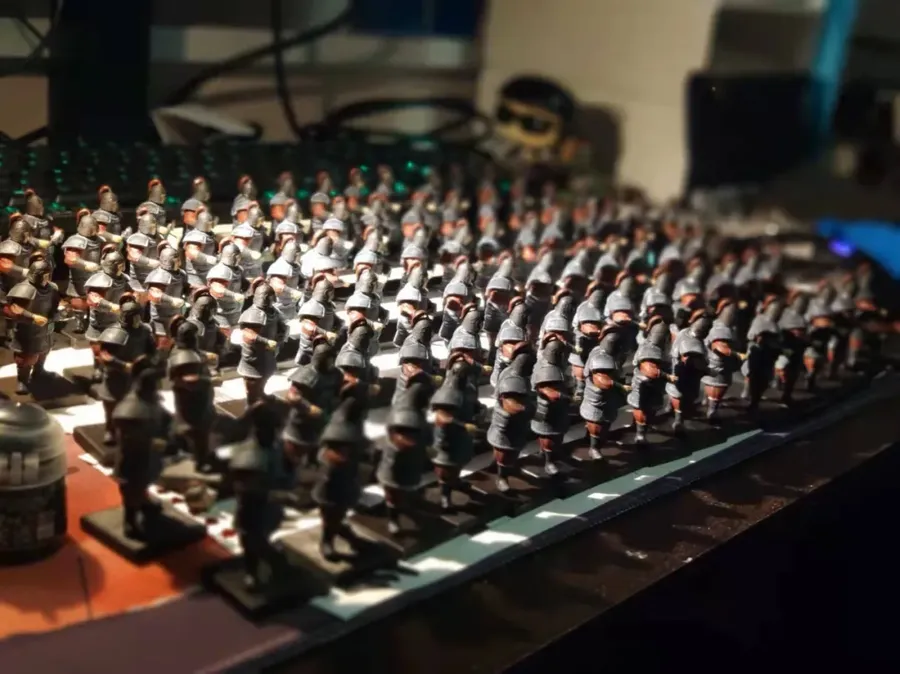 Rows of game models on a desk.