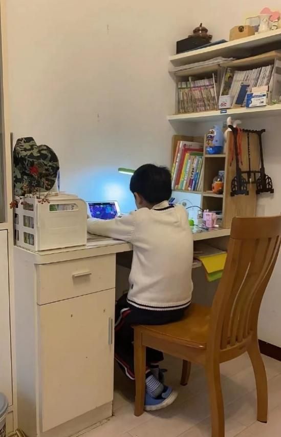 Yang&rsquo;s son playing a video game at home.