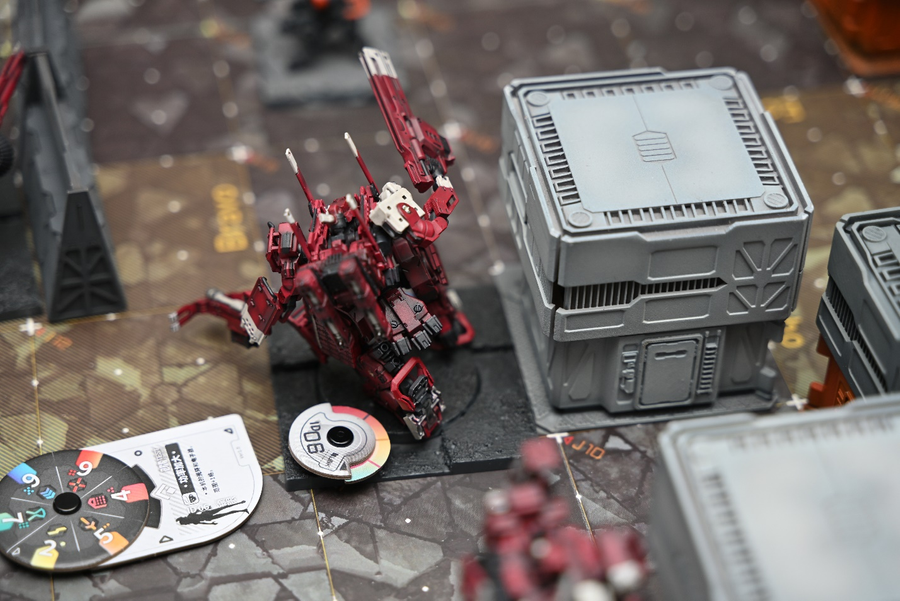 A photo of a finished model in EMBER: Obsidian Protocol, the black wheel on the left is the timing wheel.